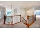 Elegant staircase featuring wood and iron railings, pendant lighting, and views of the entryway and upper level at 3904 Hounslow Ln, Harrisburg, NC 28075