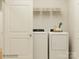 Functional laundry room with modern washer and dryer units, shelving, and ample storage at 3915 Horsham St, Indian Land, SC 29707