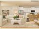 Open living room features a modern sectional, eat-in kitchen, and hardwood floors at 3915 Horsham St, Indian Land, SC 29707