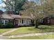 Charming single-story home featuring a cozy front porch and well-maintained lawn at 411 Woodlawn Ave, Gastonia, NC 28052