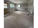Unfinished living room featuring drywall and concrete floors, ready for a personal touch at 411 Woodlawn Ave, Gastonia, NC 28052