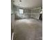 Unfinished living room with a doorway leading to another room, ready for remodeling at 411 Woodlawn Ave, Gastonia, NC 28052