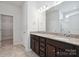 Bathroom featuring double vanities, granite countertop, ceramic tile flooring, and a glass enclosed shower at 4527 Dover Ct, Denver, NC 28037