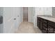 Bathroom featuring double doors leading to a walk-in closet and a vanity with granite countertop at 4527 Dover Ct, Denver, NC 28037