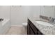 Bright bathroom with granite countertop, wood cabinets, tile floor, and tub at 4527 Dover Ct, Denver, NC 28037