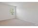 Inviting bedroom featuring neutral carpet, a window for natural light, and ample space at 4527 Dover Ct, Denver, NC 28037
