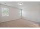 Bright bedroom with carpet floors, neutral walls, and natural light from two windows at 4527 Dover Ct, Denver, NC 28037