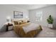 Stylishly furnished bedroom with large bed, two side tables, and bright natural light at 4527 Dover Ct, Denver, NC 28037