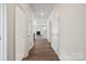 Long hallway with hardwood floors and white doors leading to various rooms at 4527 Dover Ct, Denver, NC 28037