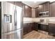 Well-equipped kitchen boasting stainless steel appliances and dark wood cabinets at 4527 Dover Ct, Denver, NC 28037