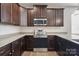 A well-designed kitchen offers dark wood cabinets, stainless steel appliances, and sleek granite countertops at 4527 Dover Ct, Denver, NC 28037