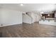 Open floor plan with hardwood floors seamlessly integrates the living space and kitchen at 4527 Dover Ct, Denver, NC 28037