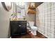 Stylish bathroom with dark cabinets, wood floors, and a shower with striped curtain at 475 Hunton Forest Nw Dr, Concord, NC 28027