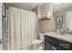 Well-lit bathroom featuring a granite countertop, wooden shelves, and a shower curtain at 475 Hunton Forest Nw Dr, Concord, NC 28027