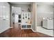 Inviting entryway with convenient bench and decor, leading to kitchen and laundry room at 475 Hunton Forest Nw Dr, Concord, NC 28027