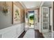 Elegant foyer with hardwood floors, white wainscoting, and an open view to the landscaped front yard at 475 Hunton Forest Nw Dr, Concord, NC 28027
