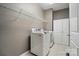 Spacious laundry room with tile floors, cabinets, and modern washer and dryer at 475 Hunton Forest Nw Dr, Concord, NC 28027