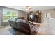 Comfortable living room with a large TV, leather furniture, and a ceiling fan at 475 Hunton Forest Nw Dr, Concord, NC 28027