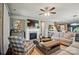 This bright living room has a fireplace, ceiling fan, and nice decor at 475 Hunton Forest Nw Dr, Concord, NC 28027