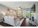 Cozy living room with dark wood floors, modern fireplace, neutral walls, and sliding door to an outdoor balcony at 475 Hunton Forest Nw Dr, Concord, NC 28027