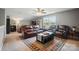 Upstairs living room with leather sofas, ceiling fan, rug and large window view at 475 Hunton Forest Nw Dr, Concord, NC 28027