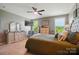 Bright main bedroom with ceiling fan, TV, and lots of natural light at 475 Hunton Forest Nw Dr, Concord, NC 28027