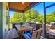 Relaxing screened-in porch with outdoor seating, ceiling fan, and views of lush greenery at 475 Hunton Forest Nw Dr, Concord, NC 28027