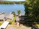 Aerial view of a lakeside property with a private dock, lush landscaping, and stunning waterfront access at 4960 Longfield St, Claremont, NC 28610