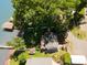 Aerial view of a lakeside home with mature trees, a cozy fire pit, and a dock at 4960 Longfield St, Claremont, NC 28610