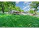 Expansive backyard view featuring a lush green lawn and a charming home nestled among mature trees at 4960 Longfield St, Claremont, NC 28610