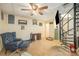 Finished basement with a dark leather chair, spiral stairs, tile floors and a ceiling fan at 4960 Longfield St, Claremont, NC 28610
