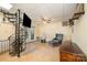 Basement with a black spiral staircase, tile floors and comfortable furnishings at 4960 Longfield St, Claremont, NC 28610