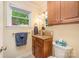 Cozy bathroom with a window overlooking a colorful garden, granite countertop and wooden cabinets at 4960 Longfield St, Claremont, NC 28610