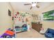 bedroom with playful decor, lots of natural light, neutral carpet and ceiling fan at 4960 Longfield St, Claremont, NC 28610