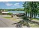 Charming lakeside home with mature trees, well-maintained landscaping, and a picturesque waterfront view from the driveway at 4960 Longfield St, Claremont, NC 28610