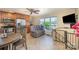 Bright kitchen with lake view, featuring stainless steel appliances, a comfortable couch, and access to the outdoor deck at 4960 Longfield St, Claremont, NC 28610