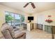 Cozy living room with tile floors, a comfortable couch, and a sliding glass door leading to the outdoor deck at 4960 Longfield St, Claremont, NC 28610