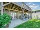 Covered patio with stone foundation, featuring a seating area and access to a lush backyard with lake views at 4960 Longfield St, Claremont, NC 28610