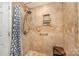 Shower featuring lovely tile work, a built-in shelf, and a convenient bench at 4960 Longfield St, Claremont, NC 28610