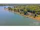 Stunning aerial perspective of the lakefront properties with lush greenery and private docks along the serene waters at 4960 Longfield St, Claremont, NC 28610