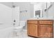Clean bathroom featuring a tiled tub and modern vanity at 526 N Davidson St, Charlotte, NC 28202