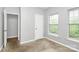 Bedroom with carpet, multiple windows, and a closet at 526 N Davidson St, Charlotte, NC 28202