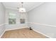 Empty bedroom with hardwood floors, trim, and natural light from two windows at 526 N Davidson St, Charlotte, NC 28202