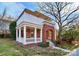 Stylish two-story home featuring a brick exterior, columned front porch, and upper-level balcony for outdoor enjoyment at 526 N Davidson St, Charlotte, NC 28202