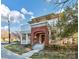 Beautiful two-story home featuring a brick facade, columned porch, second-floor balcony, and well-maintained landscaping at 526 N Davidson St, Charlotte, NC 28202