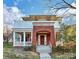 Charming two-story home with a brick entryway, columned porch, and second-floor balcony offering a classic design at 526 N Davidson St, Charlotte, NC 28202
