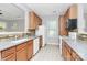 Well-lit kitchen featuring oak cabinets, white appliances, and tile backsplash at 526 N Davidson St, Charlotte, NC 28202