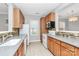 Well-lit kitchen featuring oak cabinets, white appliances, and tile backsplash at 526 N Davidson St, Charlotte, NC 28202