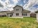 Wide backyard, patio, lawn, and siding on house, tall fence separating neighbors at 5355 Hackberry Sw Ln, Concord, NC 28027