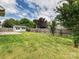 Large backyard with shed, lawn, tall wooden fence, backing up to other houses and trees at 5355 Hackberry Sw Ln, Concord, NC 28027